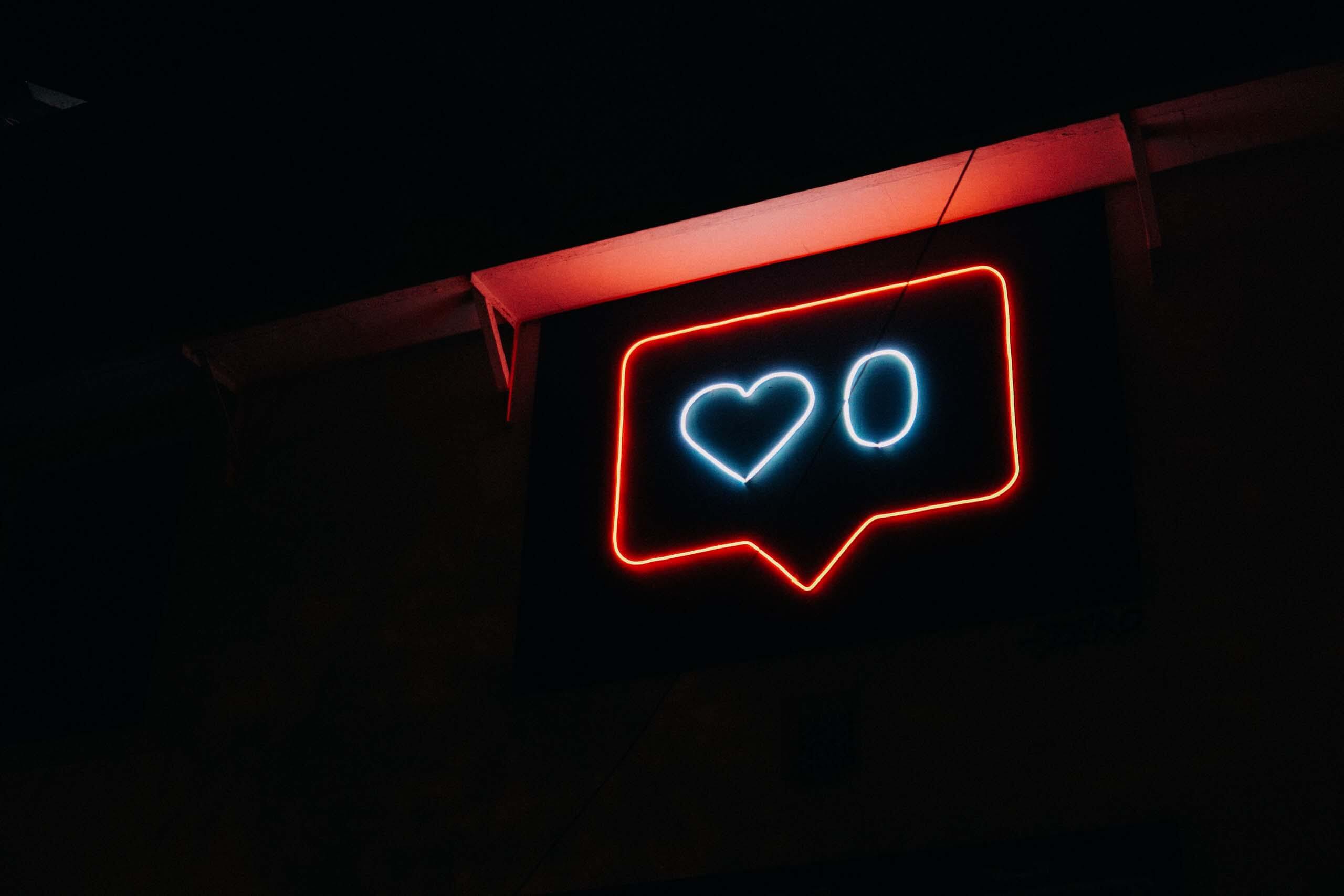 "Like Message" neon sign with dark background