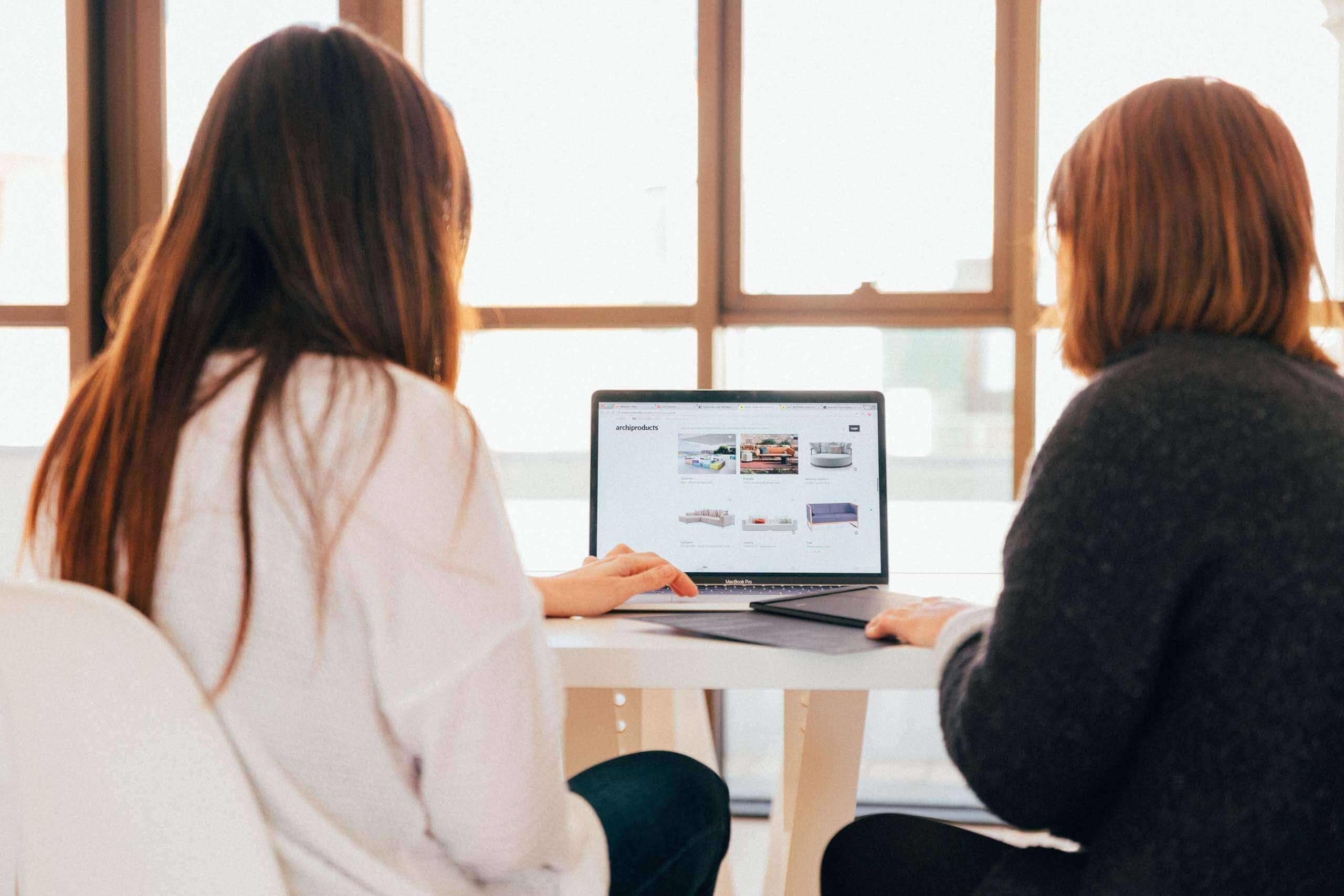 Two women looking at a laptop